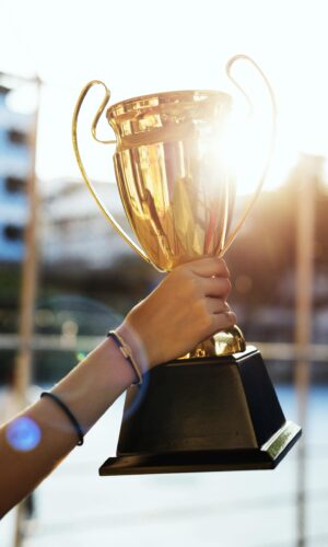 feminine-hand-holding-a-trophy